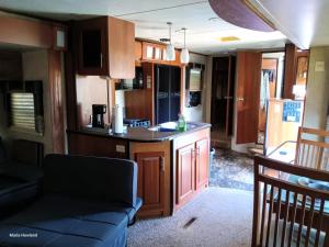 a kitchen and living room with a couch in a rv at Mountain Camper at Howland's Hideout in Sampson