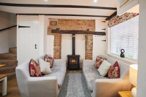a living room with two couches and a fireplace at Host & Stay - Thimble Cottage in Whitby +19 photos
