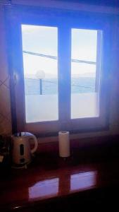 a window with two white candles in front of it at Balcones del Beagle Apart in Ushuaia
