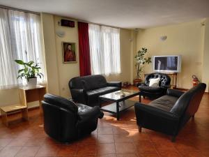 a living room with black leather furniture and a flat screen tv at Hotel Slodes in Belgrade +69 photos