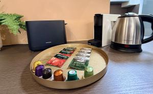 a clock on top of a table with a coffee maker at Local-Lux Premium Apartment- 2 Bedrooms Balcony -2 Private Parking in Kecskemét +46 photos