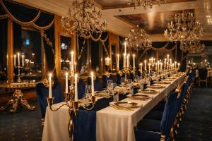 a long table in a room with chandeliers at Prezident Palace Belgrade - Rooftop Pool & Spa Hotel in Belgrade +41 photos