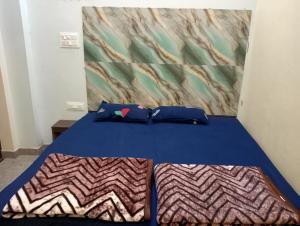 a bed with two pillows on it in a room at Krishna Hotel & Restaurant in Devaprayāg