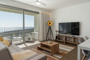 a living room with a couch and a flat screen tv at BAsia Apartment by An Island Apart in Funchal