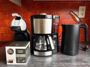 a coffee maker sitting on a counter next to a box at Vakantiehuis in Vlaamse Ardennen in Zottegem