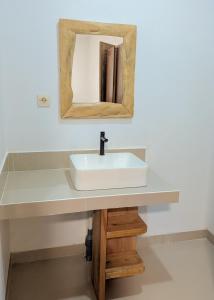 a bathroom with a sink and a mirror at A'Resta Samasta Green Lodge in Praya