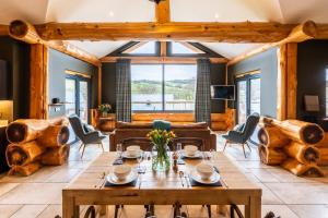 a living room with a table and chairs and a large window at Bears Den in Ilkley