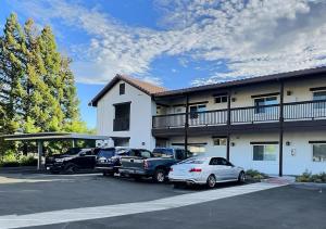 a group of cars parked in front of a building at Sonoma Grove Suites in Sonoma
