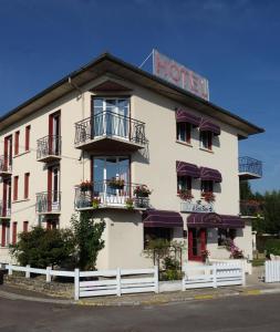 a white building with balconies and a hotel at "Contact Hôtel" Le Saint Rémy - Chalon Sud in Saint-Rémy