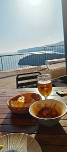 a table with a bowl of food and a glass of beer at Passage des Jardins in Sorède