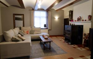 a living room with a couch and a table at Le Relais du Malpas in Namur