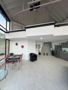 a large room with a table and chairs in it at Afrodita Chalet in El Peñol