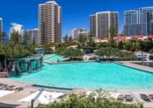 a large swimming pool in a city with tall buildings at Q Resort on Hamilton Avenue - Hosted by Gold Coast Luxury Resorts in Gold Coast