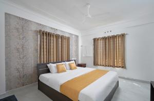 a bedroom with a large bed with yellow pillows at BHRS Residency in Munnar