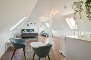 a living room with a couch and a table and chairs at Ferienwohnung Big Family in Ichenhausen
