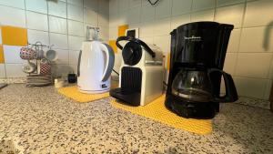 a kitchen counter with a coffee maker and a blender at Casa Zia Pia in Baveno