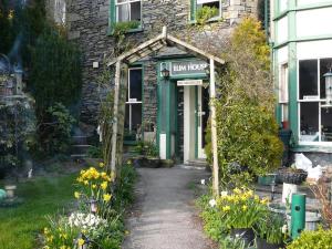 a stone building with a sign that reads lawn house at Elim House in Bowness-on-Windermere