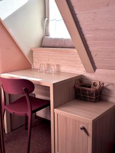 a bathroom with a sink and a desk with a chair at Guest House "Arkhistratyg" in Lviv
