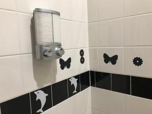 a bathroom with black and white tiles and butterflies at MANHATTAN ROSE Homestay in New York