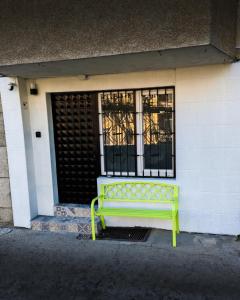 a yellow bench sitting in front of a building at Studio Dimon in Pleven