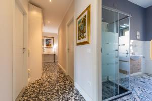 a hallway with a glass door leading to a bathroom at Lorixedda Rooms in Quartu SantʼElena