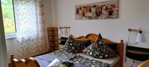 a bedroom with a bed with pillows on it at Ferien im Kühbergstadl in Bischofsmais