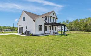 a large white house with a large grass field at Luxurious Eastern Shore Getaway in Milton