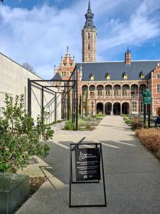 a large building with a sign in front of it at Het Maelslot (Mechelen) in Mechelen
