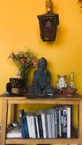 a book shelf with a buddha statue and books at La Chakana Pisac in Pisac +28 photos