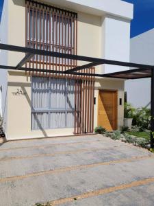 a white house with a staircase on the side of it at Damani Modern Pool Villa Escape in Punta Cana