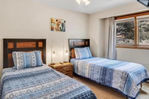 a bedroom with two beds and a window at River Park 1241 in Ouray