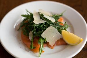 a plate of food with a salad and a lemon at Stella Maris Hotel in Kilkee
