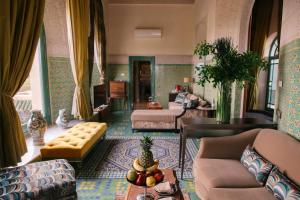 a living room with a couch and a table at Palais Faraj Suites & Spa in Fez