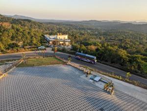 an overhead view of a bus driving down a road at Oxyrich Business Class Hotel in Madikeri