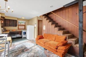 a living room with a couch and a staircase at Singer Cabin 2 in Ridgway +11 photos