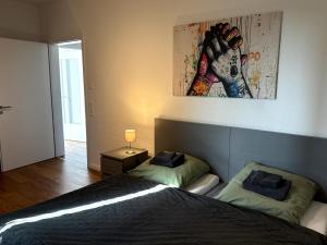 a bedroom with two beds and a painting on the wall at Apartment Landblick in Bohmte