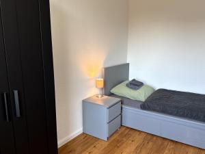 a bedroom with a bed with a lamp on a night stand at Apartment Landblick in Bohmte +4 photos