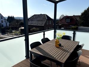a table and chairs on a balcony with a view at Apartment Landblick in Bohmte
