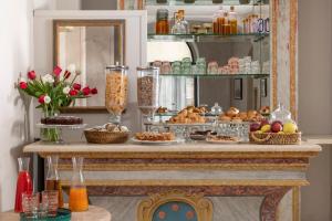 a table with bread and other food on it at Hotel Galileo in Florence