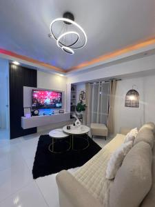 a living room with a couch and a tv at LUCKY 7 Suites in Manila