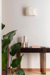 a console table in a living room with a plant at Hotel Galileo in Florence +26 photos