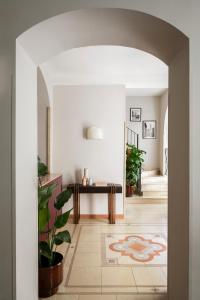a hallway with a table and a potted plant at Hotel Galileo in Florence