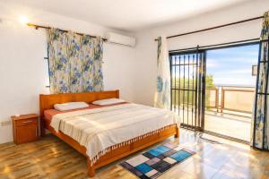 a bedroom with a bed and a large window at Hope Villa in Calodyne