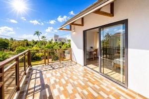 a balcony of a house with glass doors at Hope Villa in Calodyne