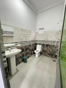 a bathroom with a sink and a toilet at Diyathna Nuwarawewa in Anuradhapura