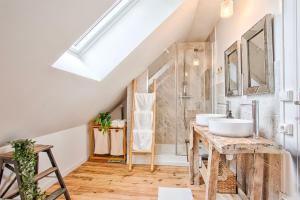 a bathroom with two sinks and a shower at L'échappée du Cotentin in Cherbourg en Cotentin +32 photos