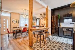 a kitchen and dining room with a table and chairs at L'échappée du Cotentin in Cherbourg en Cotentin