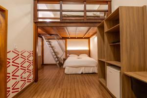 a bedroom with a bunk bed and a ladder at Vektor Hotéis - Unidade Mariana in Mariana +71 photos