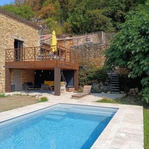 a large swimming pool in front of a house at Les Mas d Olema in Puy-lʼÉvêque