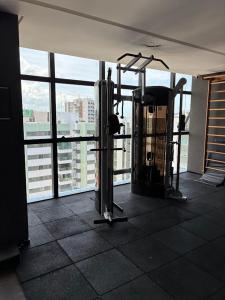 a gym with a view of a city from an office building at TIME Ponta Verde in Maceió